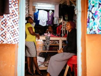 Zipporah with two other women inside the doorway of her store