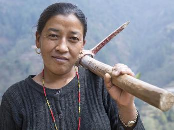 Woman with tool over her shoulder