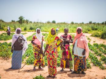 Women in niger standing in front of a field