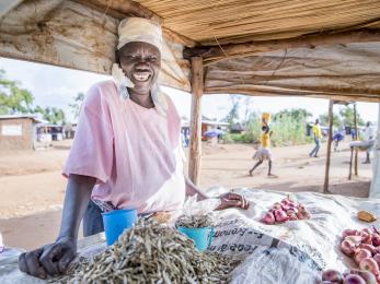 Smiling woman at market stand