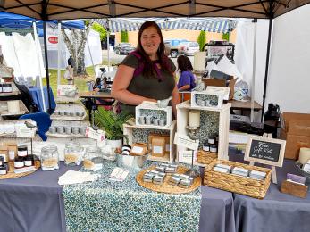 Woman working at a jewelry stand.