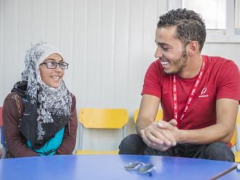 Amani speaking with a mercy corps employee