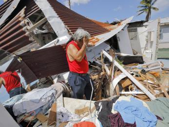 Man among hurricane maria rubble
