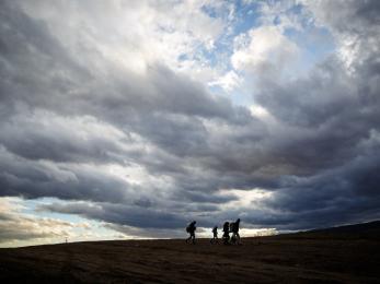 People walking with cloudy sky behind them in serbia