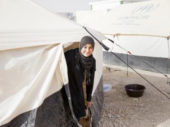 Nour leaves her tent in the refugee camp