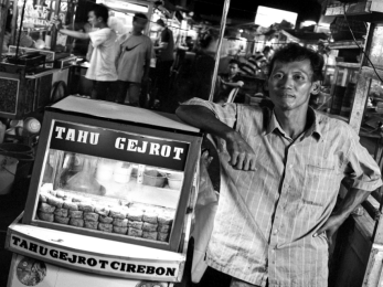 Man standing next to food station