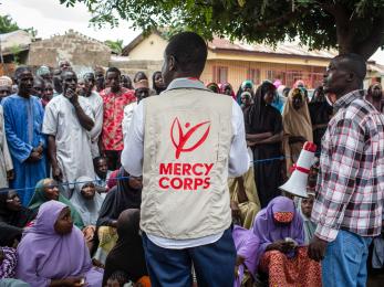 Mercy corps team member facilitating a community meeting