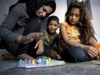 A young boy and girl playing a board game