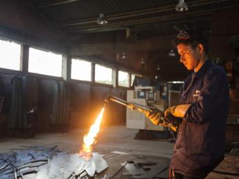 Young man working with blow torch
