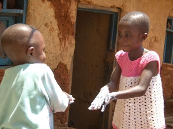 Christine, 6, and her little brother gabriel, 3, practice their hand washing techniques. photo: rudy nkombo/mercy corps