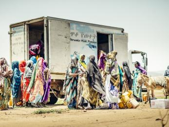 Women gathering around a truck