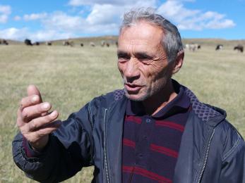 Man in field speaking