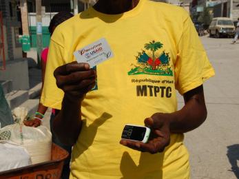 Man holding mobile phone and cash card