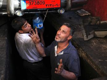 Man and boy working in street