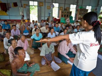 Mercy corps team member speaking to community