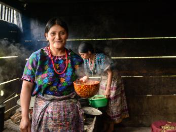 Two women cooking in guatemala. photo: miguel samper for mercy corps