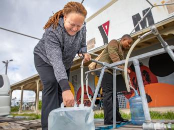 Bahamian filling water jug.