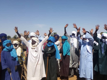 A group of people with their hands in the air.