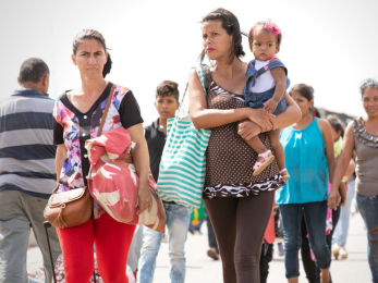 Families walking together at a border crossing.