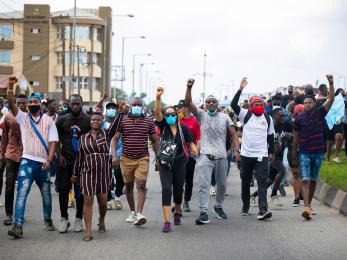 A group of protestors marching down a street.