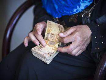 A persons hands counting cash money. 