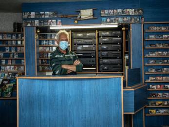 A vendor standing in a music store. 