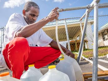 Bahamian filling water jugs.
