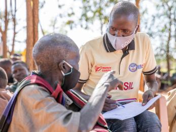 Mercy corps team member, james longok, speaks with people in karamoja during a peace-building session.