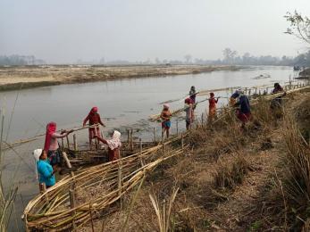 Women in badabaika, nepal build bamboo spurs to protect their land from floods.