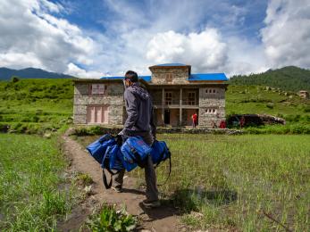 A health worker delivering covid-19 kits to an isolation center in jumla, nepal.
