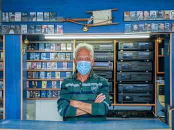 A business owner standing in their store.