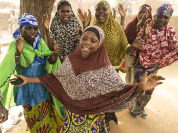 Teenage girls singing together.