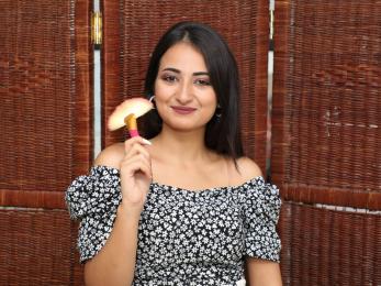 A person holding a makeup brush.