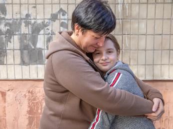 A parent hugs their daughter in dnipro, ukraine. 