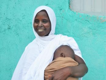 An adult holding a baby.