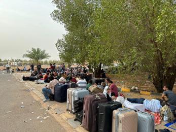 People wait to be evacuated near an airport in Omdurman, Sudan, April 26, 2023. As conflict continues in Sudan, many people have fled to neighboring countries. Photo by Xinhua via Getty Images