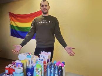 A person displaying personal care and hygiene supplies for displaced persons.