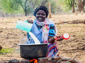 A person skimming milk.