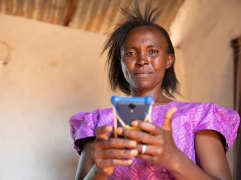 Lydia with cell phone in kenya