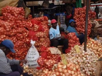 Farmers sitting with bundles of their produce