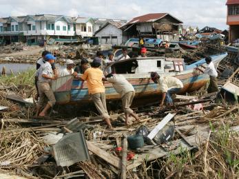 In Meulaboh, Indonesia, local fisherman clear boats and debris inland in the weeks after the devastating earthquake and tsunami in 2004.