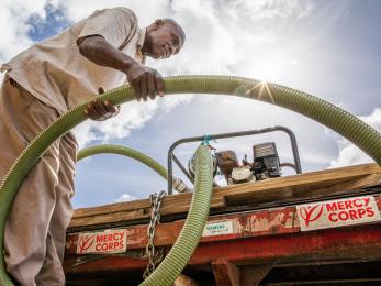 Bahamian working with a water tender truck.