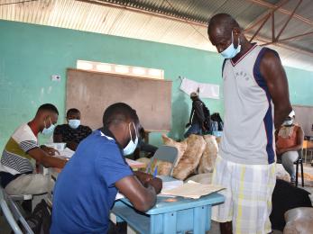 A farmer signing up to receive supplies as part of a long-term recovery program. 