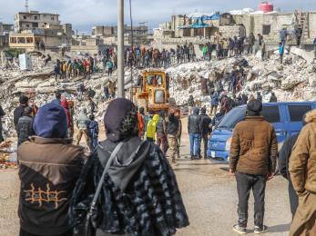 In Harim Syria, people and rescue crews gather around collapsed buildings following the 7.8 magnitude earthquake.