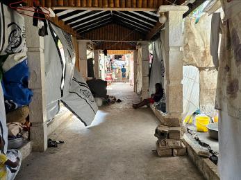 Photo of an covered outdoor walkway that leads to club international rotary in haiti, which is housing idps.